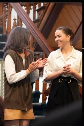 Lia speaking with a guest on the staircase at Carclew House